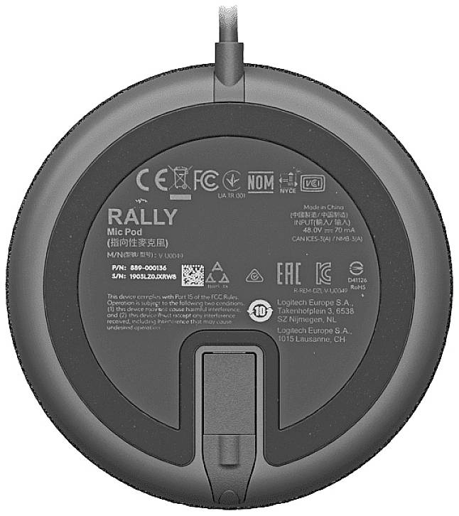 The underside of a round device with manufacturer markings, model numbers, and logos. Important information and compliance symbols are displayed.