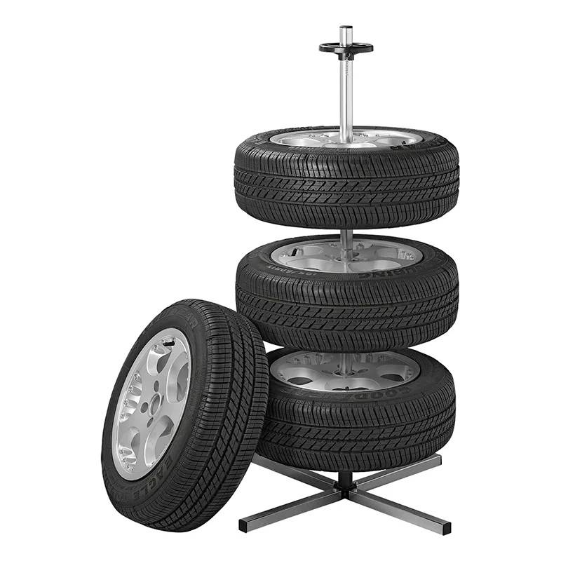 A tyre tower with four stacked car tyres on a stand. An additional tyre leans at the front. Ideal for tyre storage.