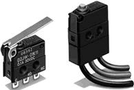 Two black micro switches. On the left is a switch with a metal lever, on the right is one with cable connections at the bottom.