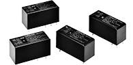 Four black, rectangular relays with metal pins on the underside, suitable for electronic circuits and controls.