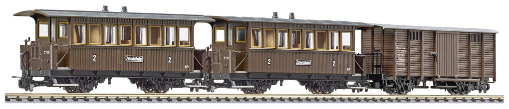 Brown model train with two passenger carriages and a goods wagon, positioned on a model railway track.