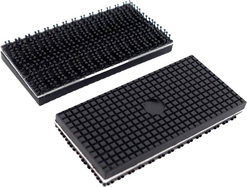 Two rectangular objects with numerous small protrusions on the surface. One lies flat, the other is leaning at an angle.