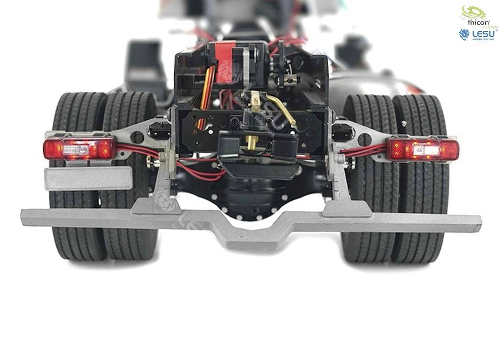 Lorry chassis with wheels, suspension and brake lights, viewed from behind. Technical representation of vehicle engineering.