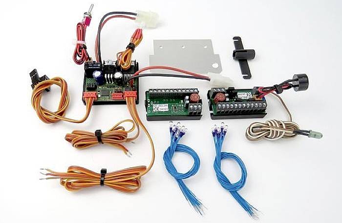 Electronic component set on a white background, consisting of circuit boards, cables, and connectors, suitable for model building.