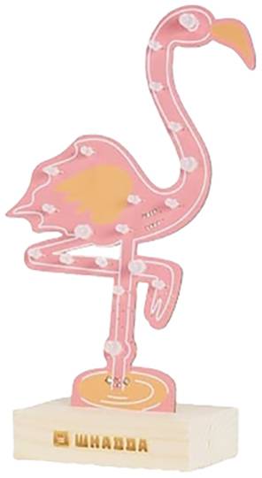 Pink neon lamp in the shape of a flamingo on a wooden block.