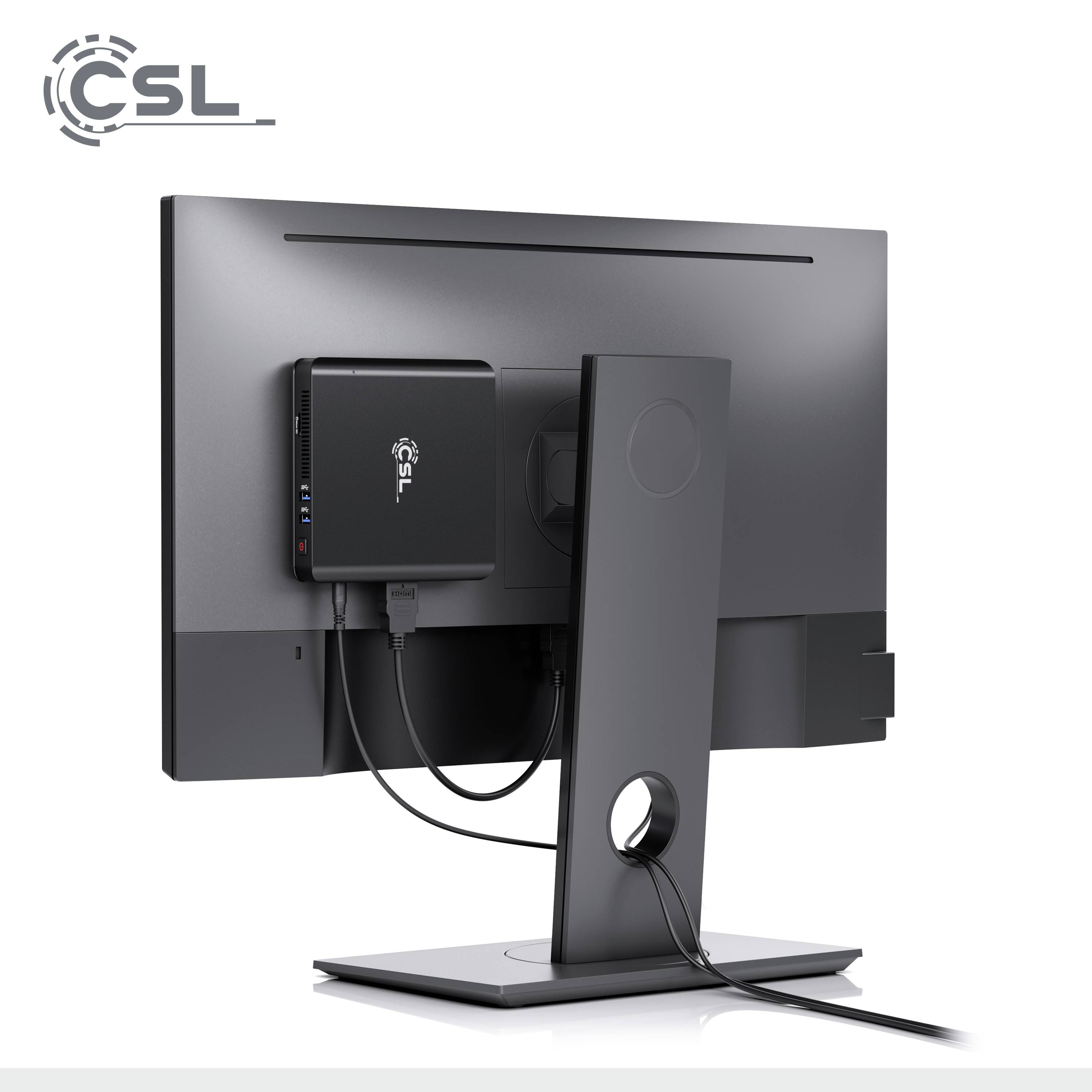 A mini PC from CSL is mounted on the back of a monitor. The PC is black and has connection cables that are neatly routed.