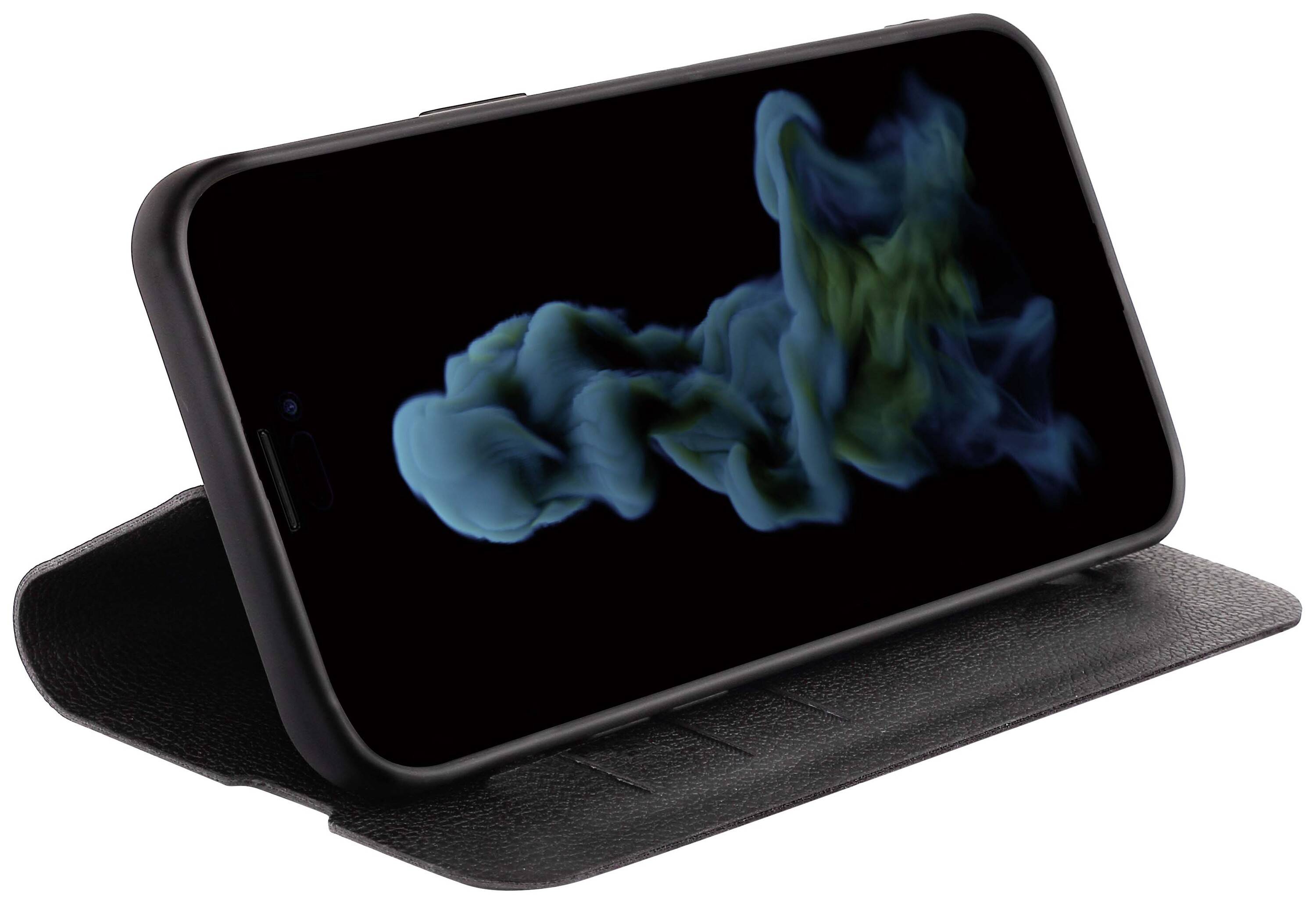 A smartphone is sitting in a black case. An abstract blue and green smoke cloud is displayed on the screen against a black background.