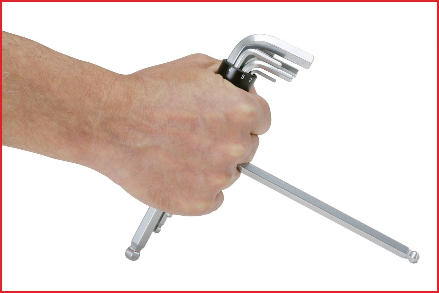 A hand holds a set of six silver Allen keys in various sizes, ready for use.