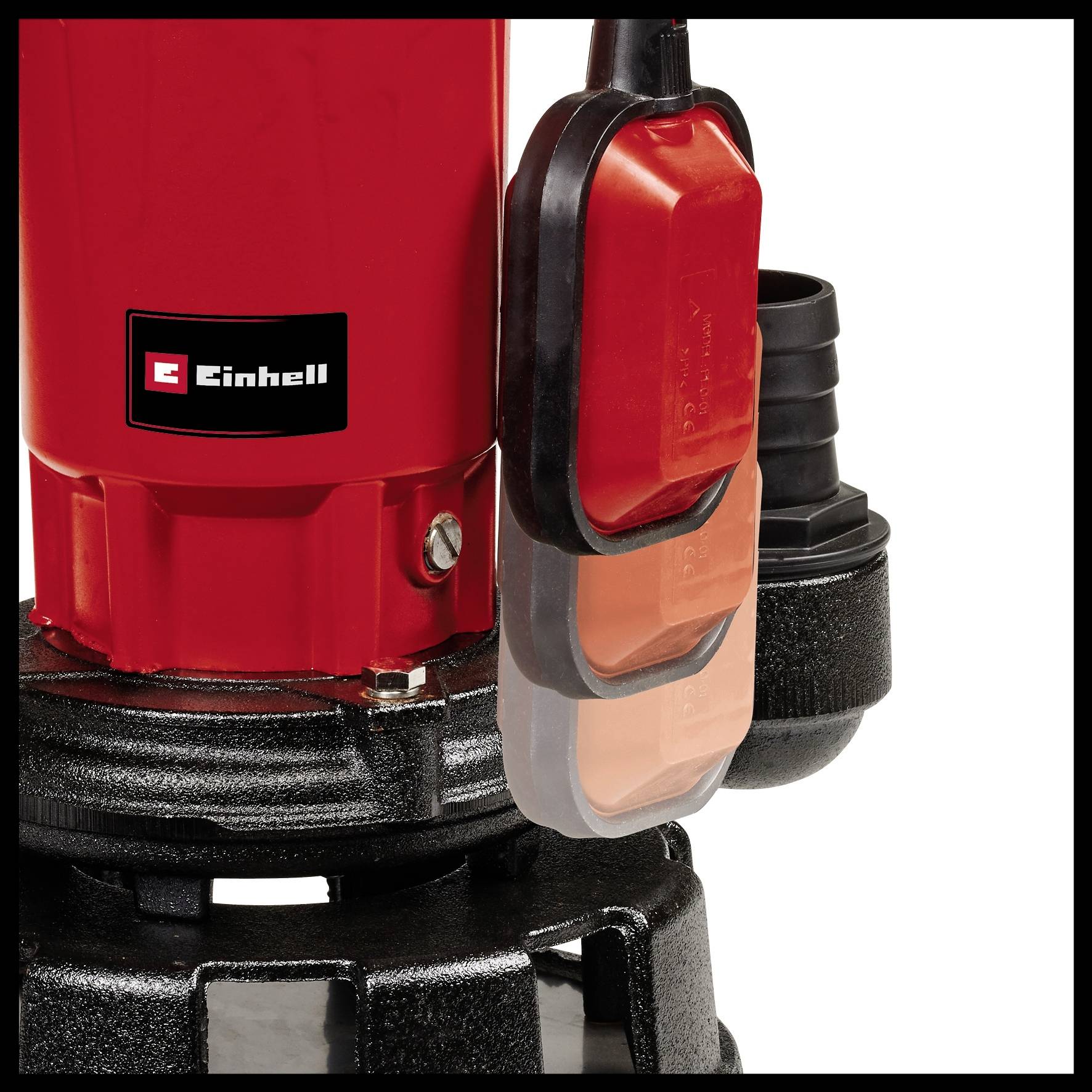 A detail of a red pump with the Einhell logo, showing a switch and black water outlet, part of a pumping or drainage system.