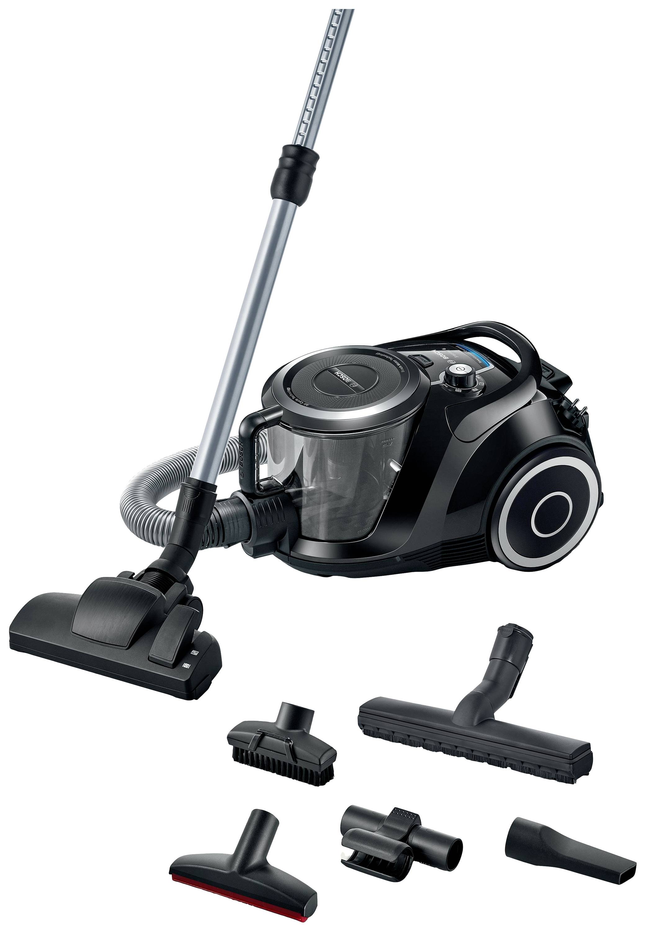 A black vacuum cleaner with multiple attachments. The vacuum cleaner is cylindrical and has a transparent chamber for dirt.