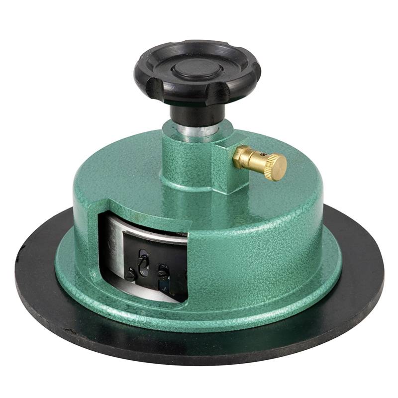 Green rotary knob on a round, sturdy metal base. Used for precise positioning or adjustment in mechanical devices.