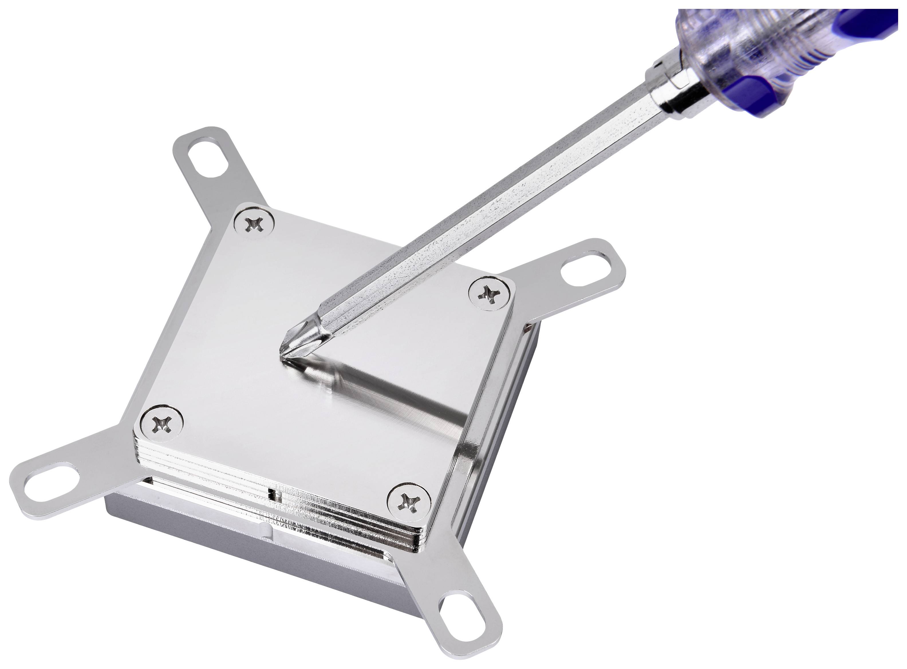 A screwdriver tightens a screw on a metallic heatsink displaying computer hardware.