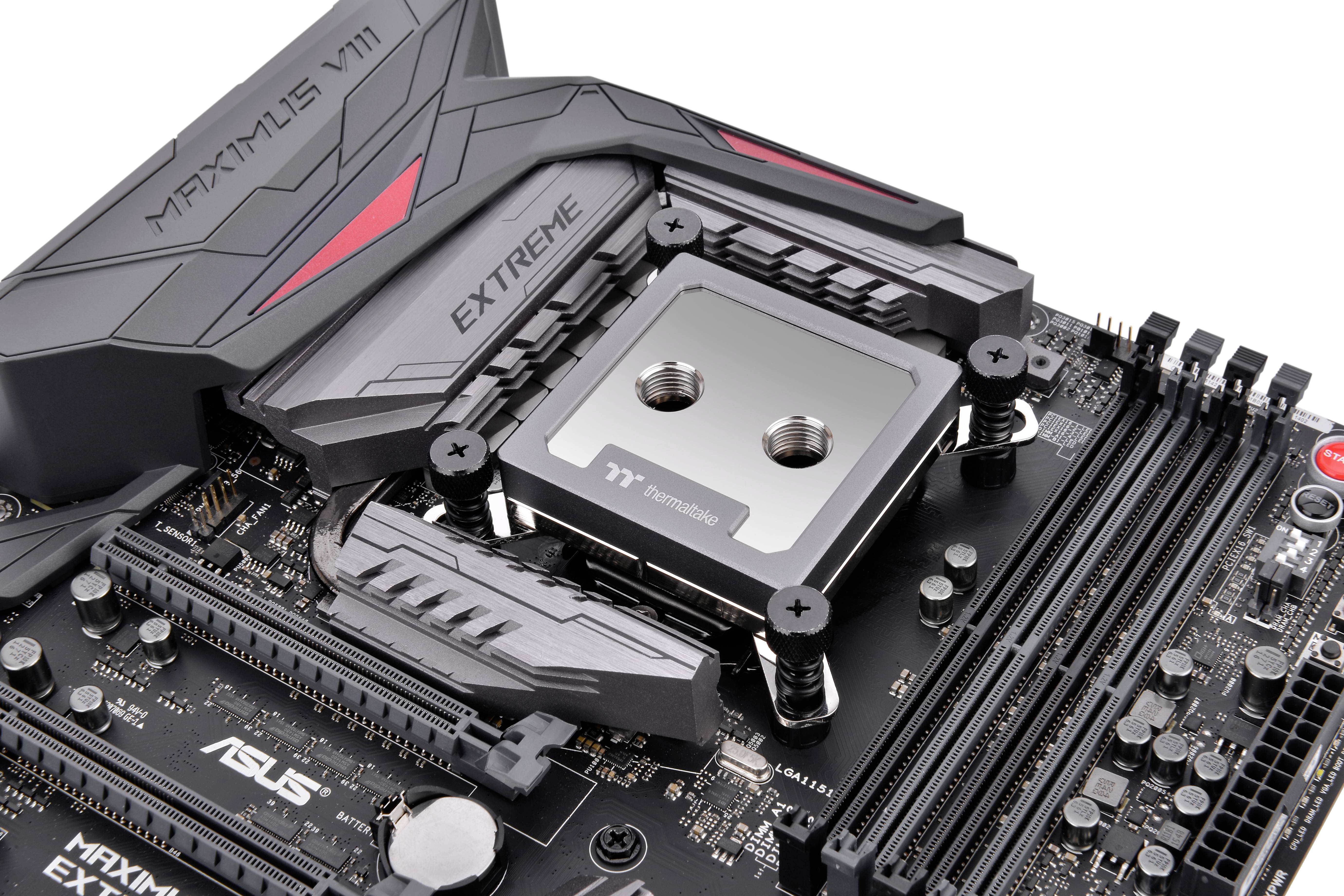 Motherboard with water-cooled CPU socket on an ASUS Maximus VIII Extreme. Cooling ports and RAM slots are visible.