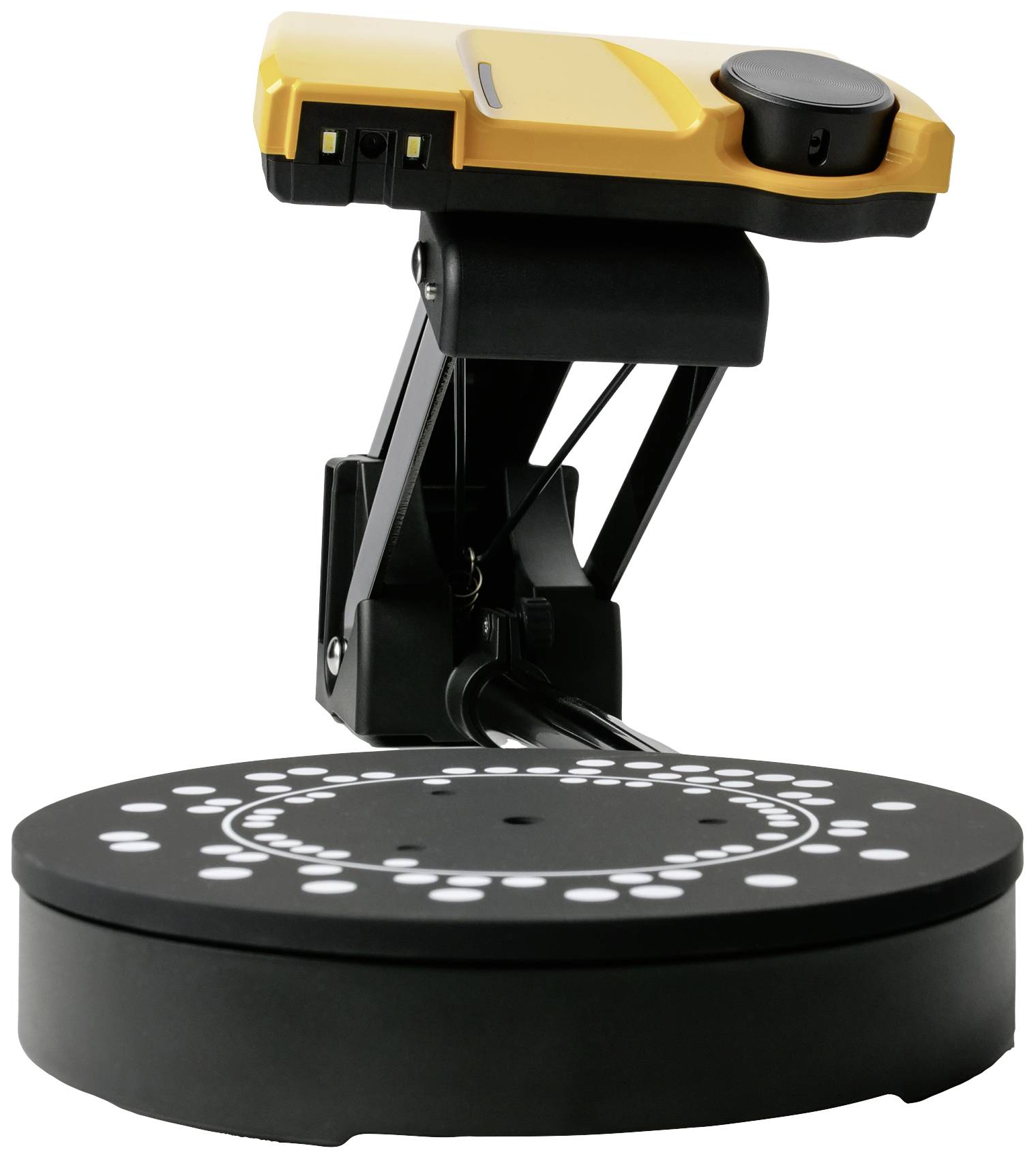 A 3D scanner with a yellow housing, mounted on a black rotating base. It contains white-marked calibration points.