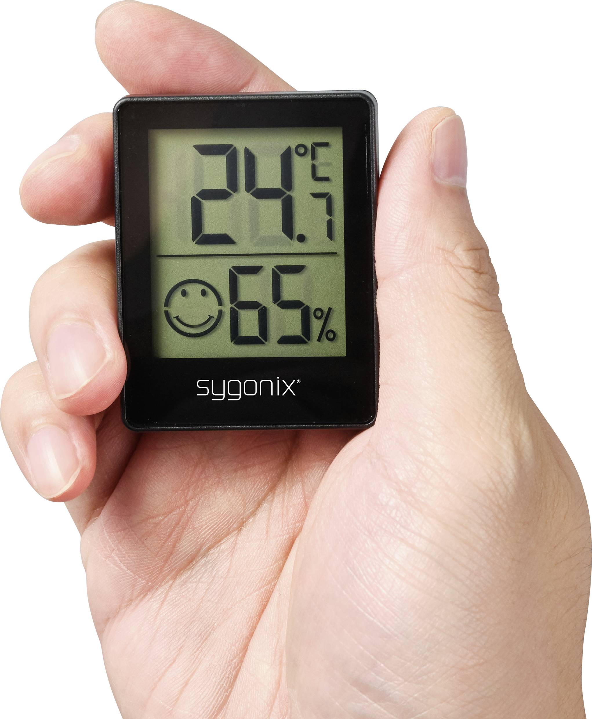 Ein Hand hält ein digitales Thermo-Hygrometer. Es zeigt '24,7°C' und eine Luftfeuchtigkeit von '65%' mit einem lächelnden Gesichtssymbol.