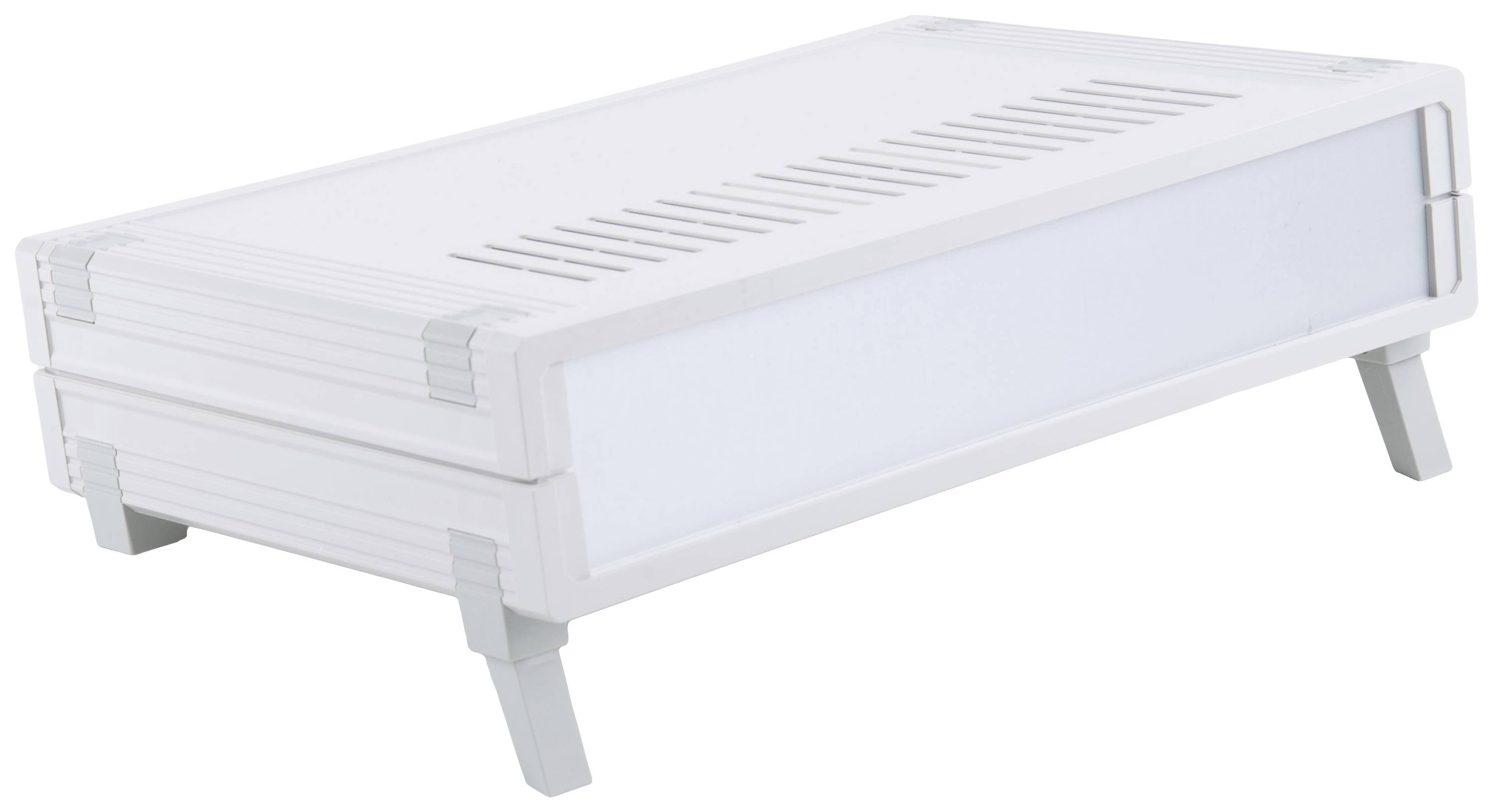 A white, rectangular plastic container with ventilation slots on a table, supported by four small legs.