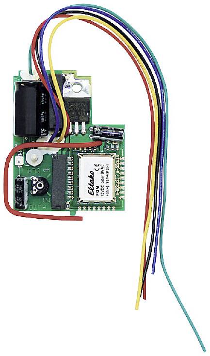 A small green printed circuit board with multiple coloured wires and electronic components, including a chip and a capacitor.