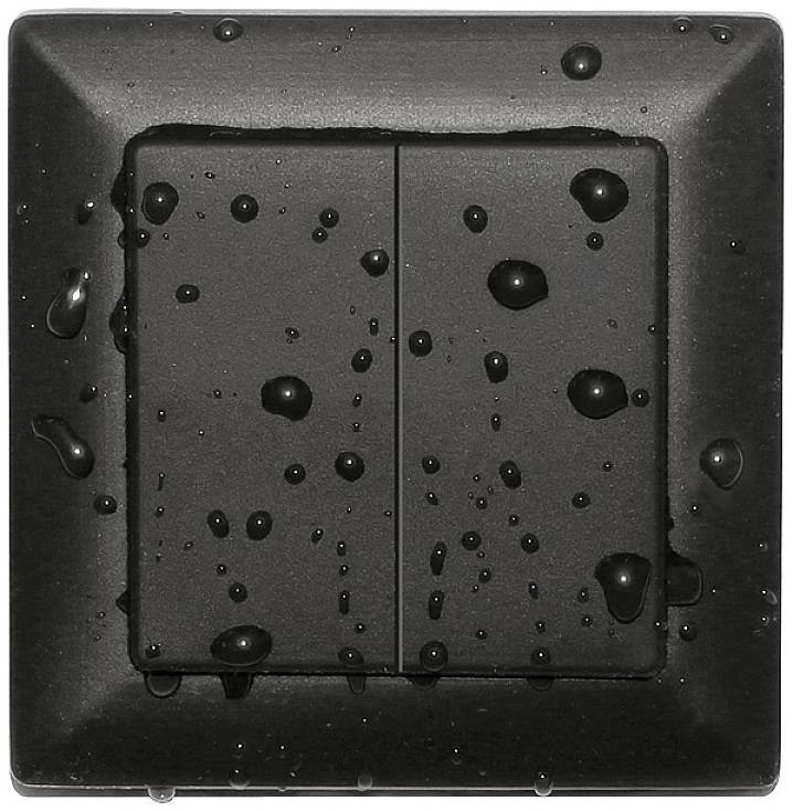 A wet, black light switch with water droplets on its surface.