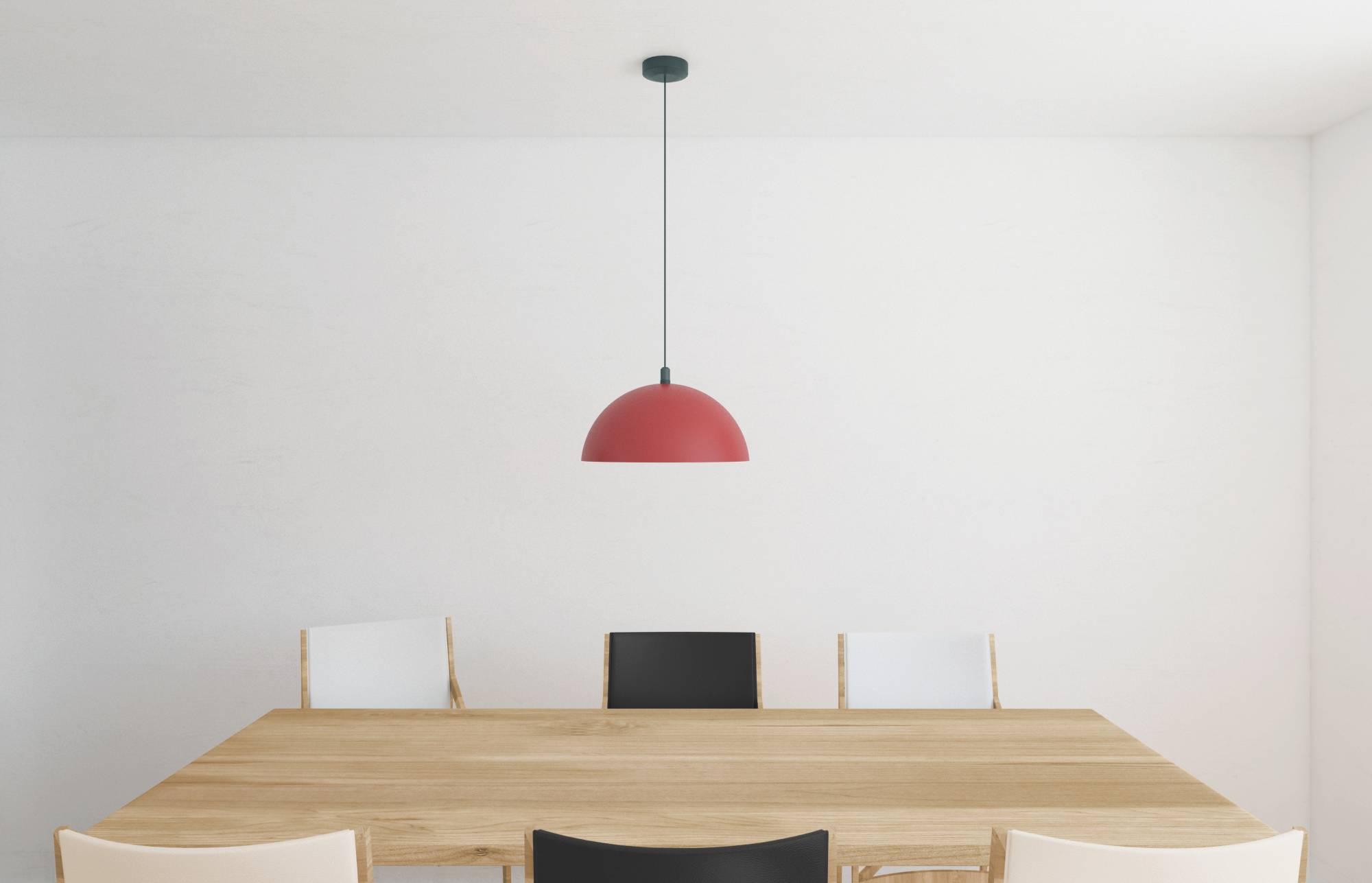 A minimalist dining room with a wooden table, four chairs, and a red pendant light hanging above. The walls are plain white.