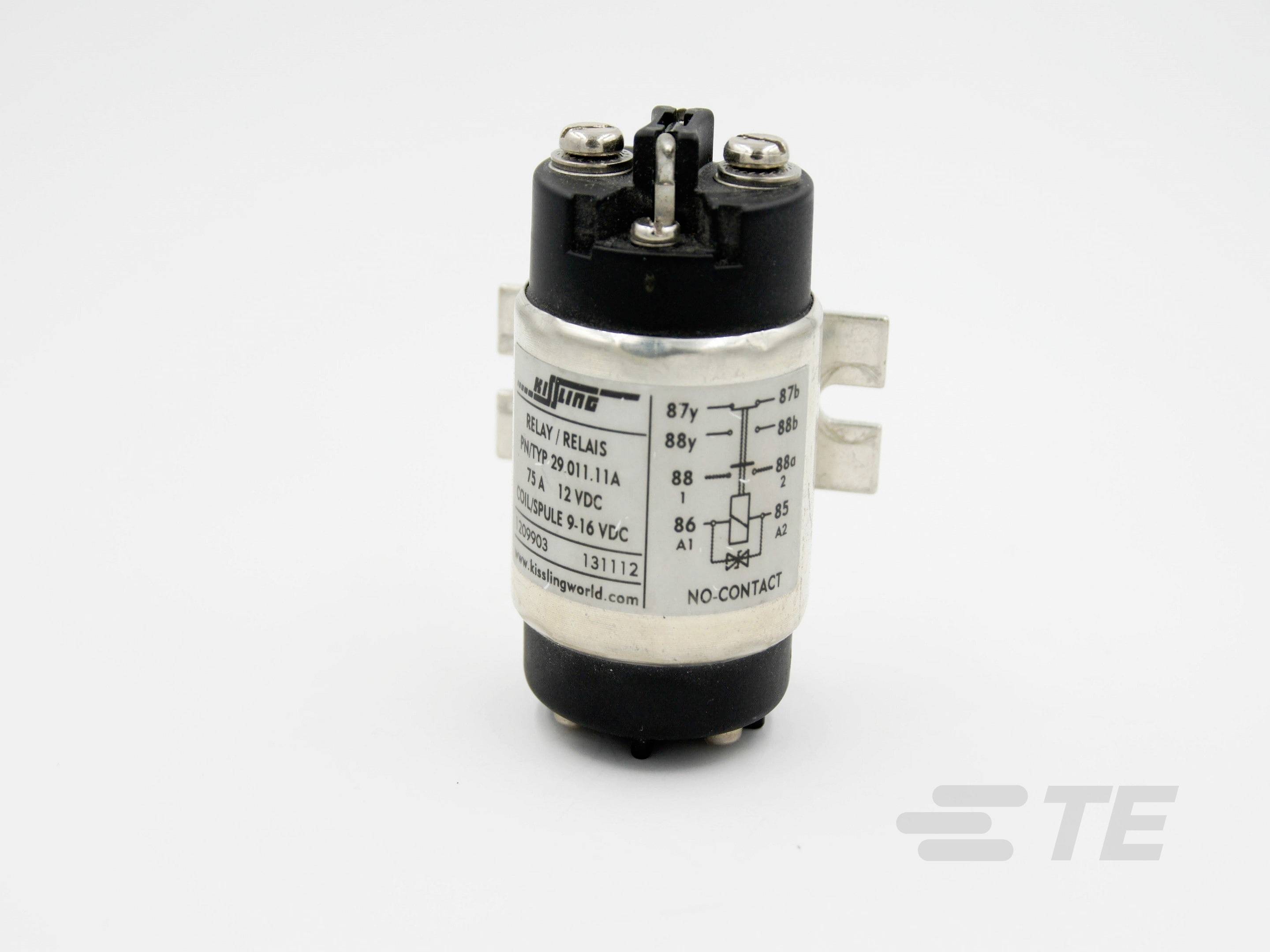 A cylindrical, black and silver relay with connection terminals and a label displaying technical details and voltage specifications.