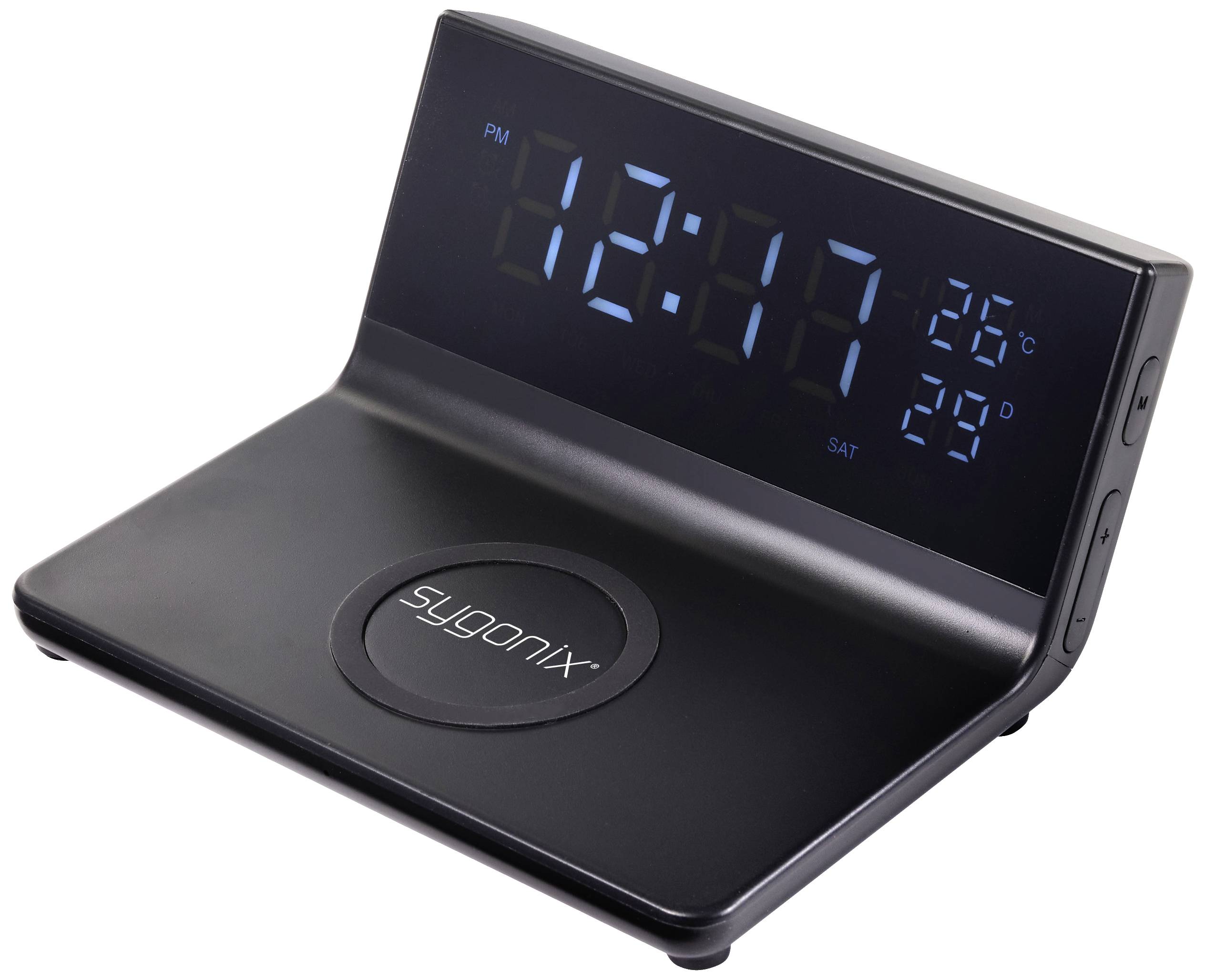 Black digital alarm clock shows 12:17, temperature 26°C, date 'Saturday'. Contains induction charging device on its surface.