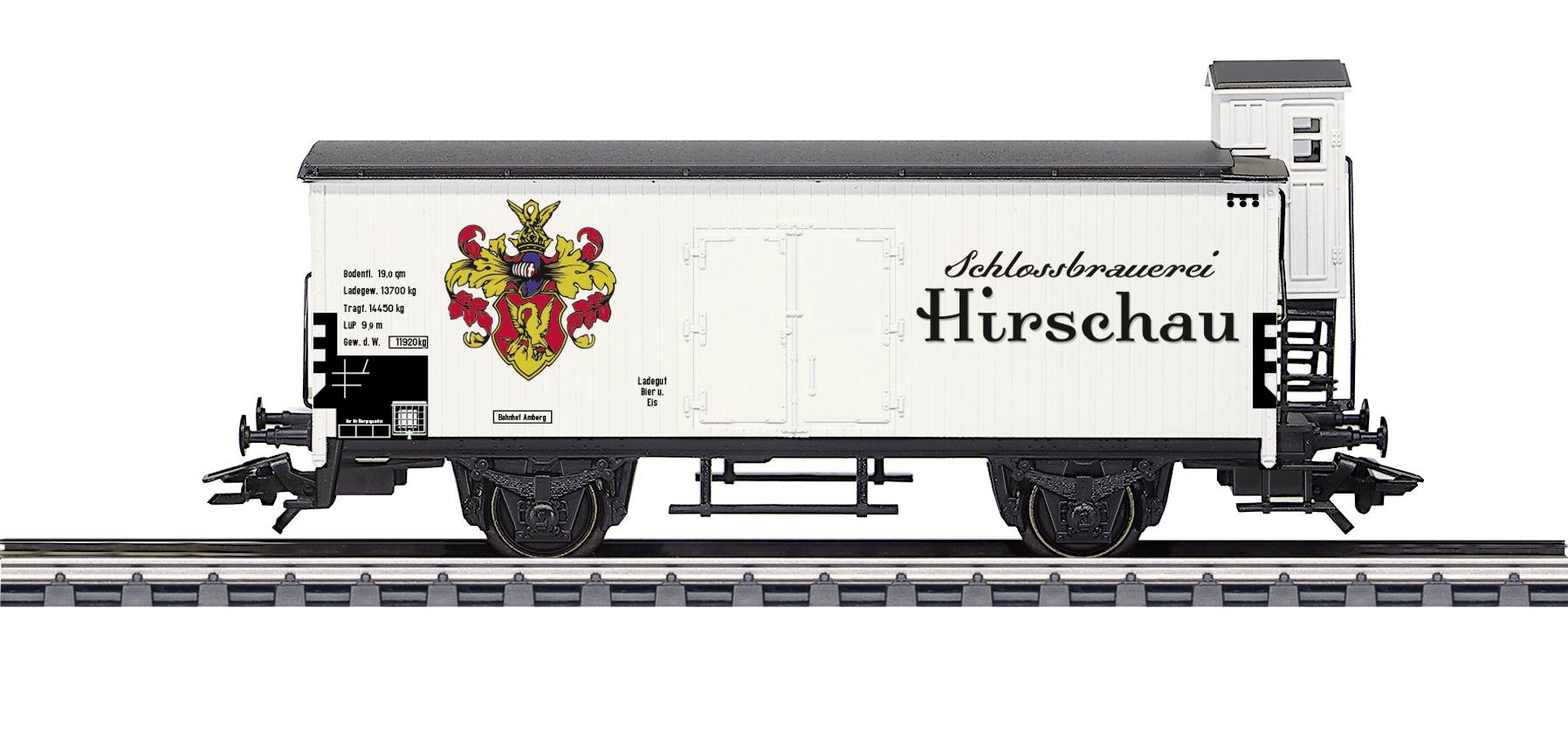 A model of a goods wagon from the 'Schlossbrauerei Hirschau' with a coat of arms, stands on railway tracks. White wagon, detailed design.