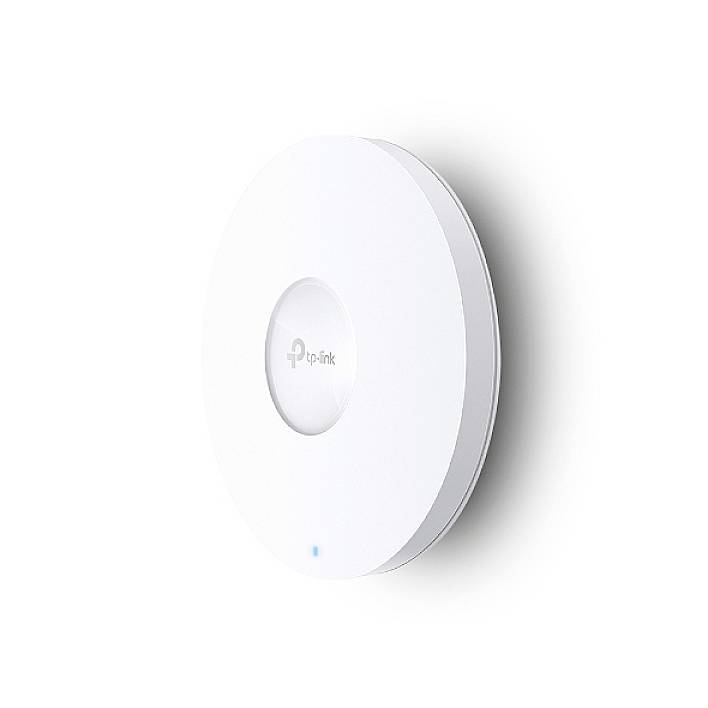 Round, white TP-Link Wi-Fi device mounted on the wall. Blue LEDs are illuminated, indicating an active connection.