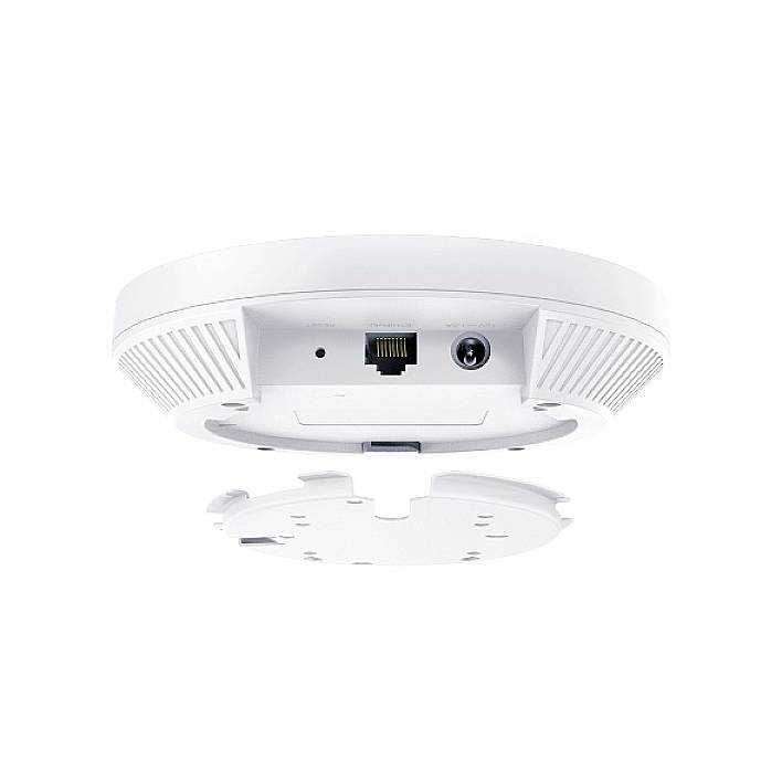 A white, circular Wi-Fi access point viewed from below, showing an Ethernet port and a power connection in the centre of its underside.