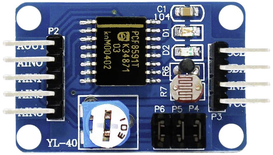 Electronic module with a black IC in the centre, surrounded by capacitors, resistors, and connectors on a blue circuit board.