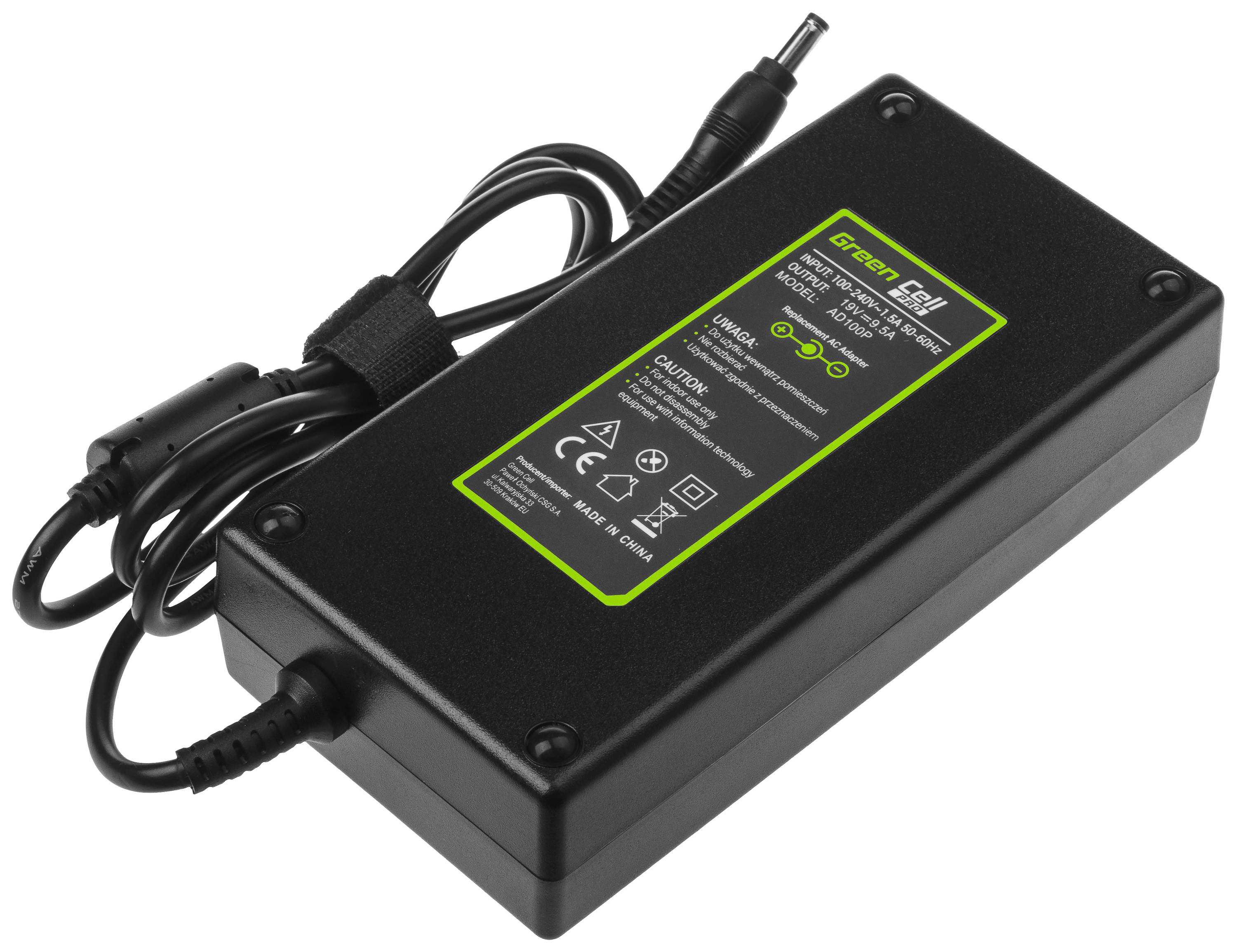A rectangular charger with a green label and black cable. Text on the label displays specifications and safety symbols.