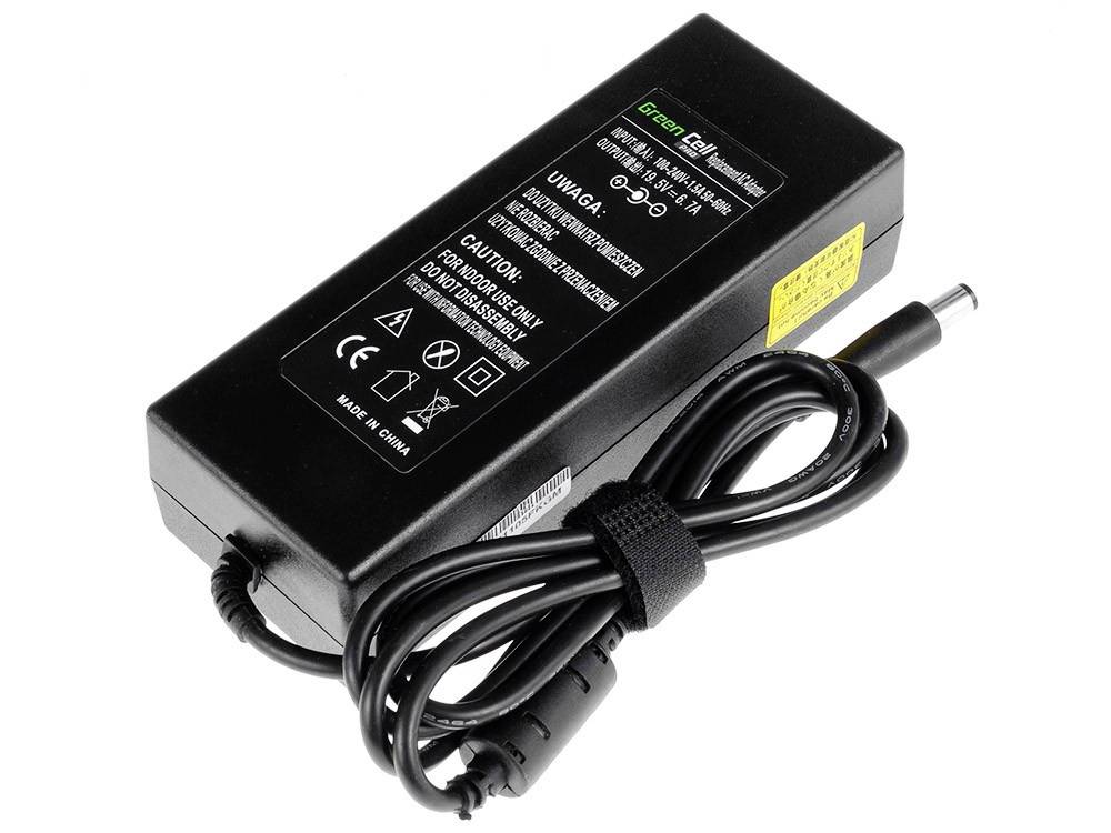 Black power supply with cable and labels; yellow label on the side, multiple symbols on top; suitable for device power supply.