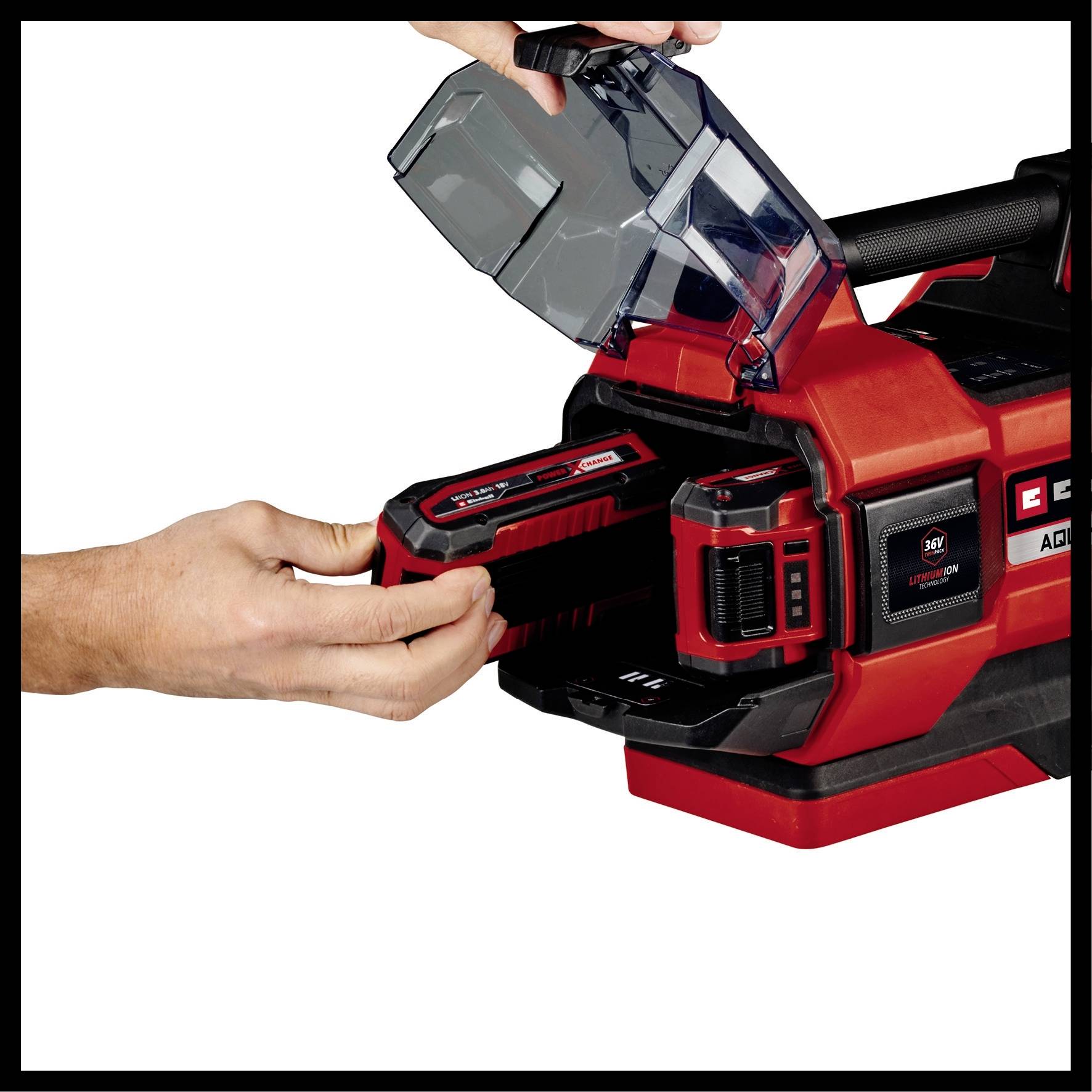 A person is inserting a red battery into an electrical tool charger. The lid of the charger is open.