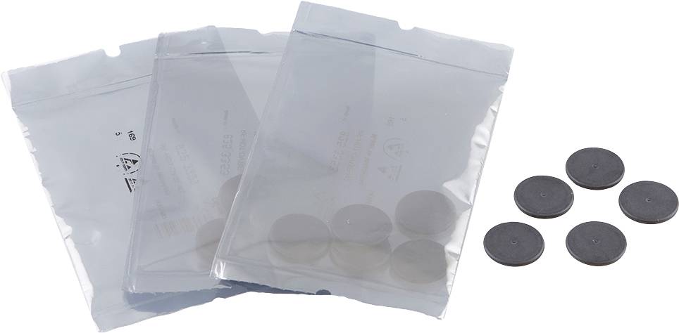 Three sealed plastic bags, each containing four flat, round black objects; alongside six loose identical objects.