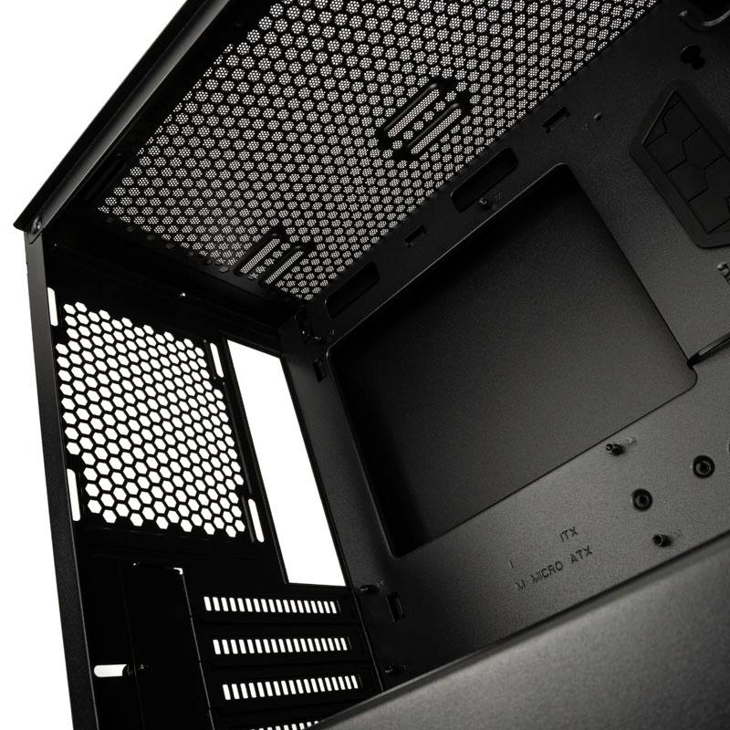 Interior view of a computer case, black, with ventilation grilles and mounting slots for various motherboard sizes.