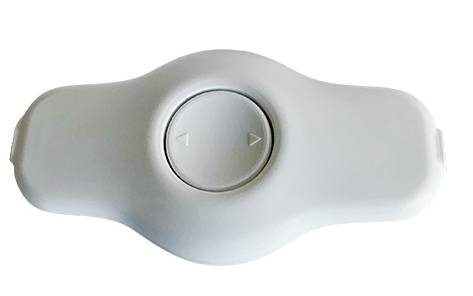 A white, oval device with a central circle containing two small arrow symbols pointing in opposite directions.