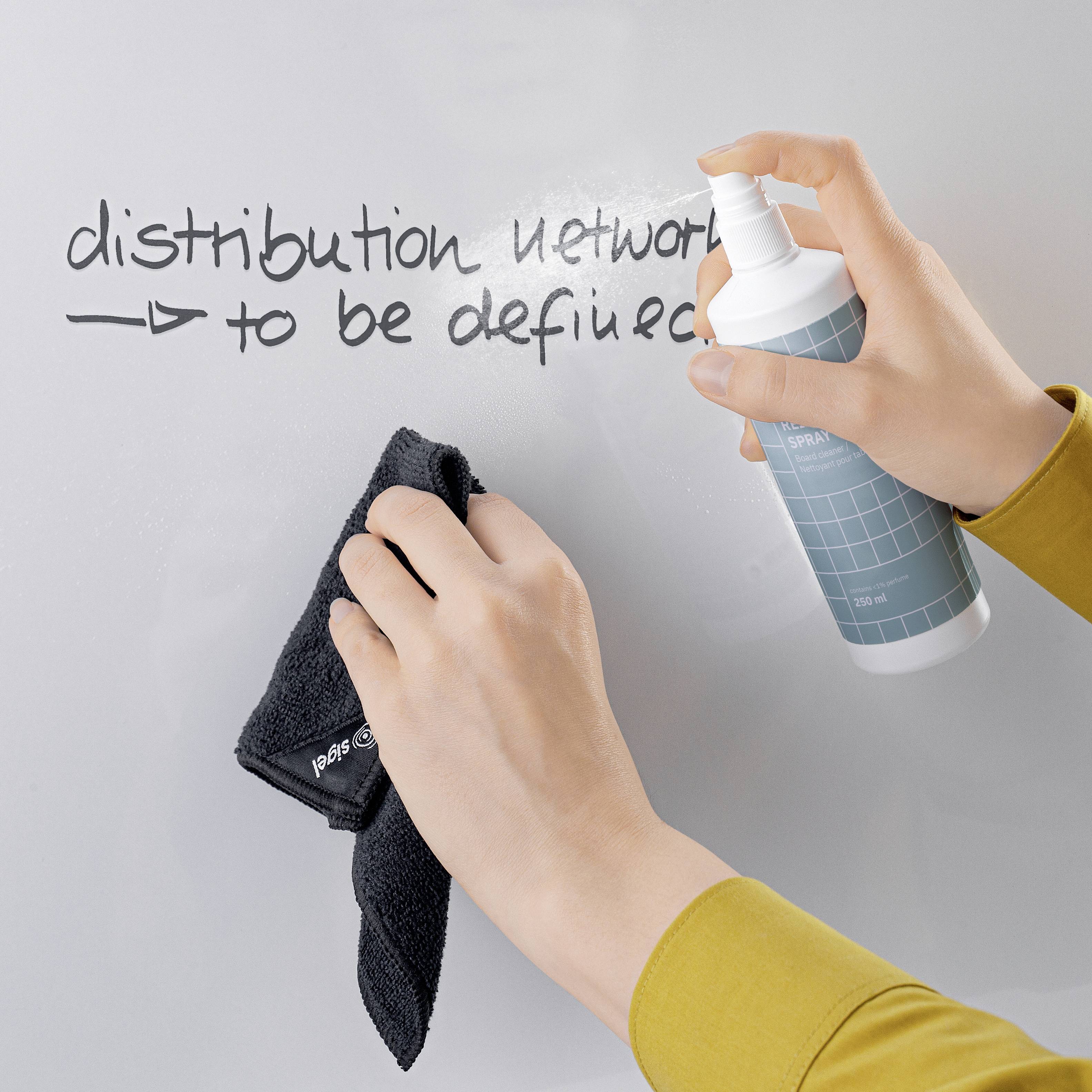A hand sprays cleaning solution onto a board while another hand wipes with a cloth; 'distribution network' noted.