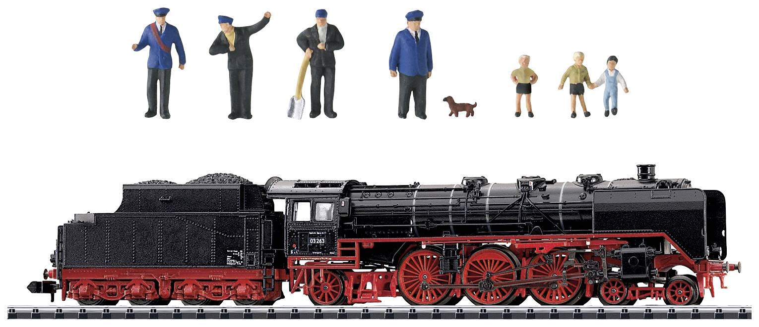 Model railway locomotive with red chassis and black details. On top, small model figures of people and a dog.
