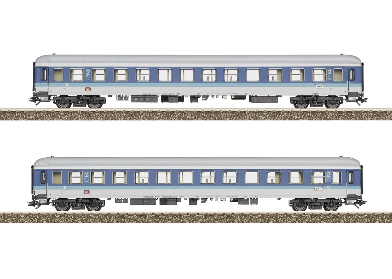 Two blue railway carriages are standing on tracks. The carriages have large windows and are identically designed.