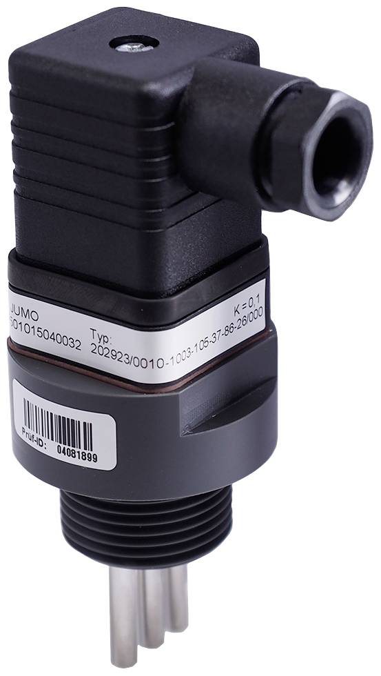 A sensor for industrial applications with a black housing and metal pins, fitted with a nameplate displaying technical specifications.