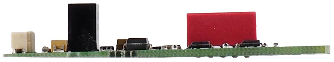Side view of a green electronic circuit board with various black, red, and beige components, showing minimal wiring.(Note: This description is already in British English and requires no translation changes.)
