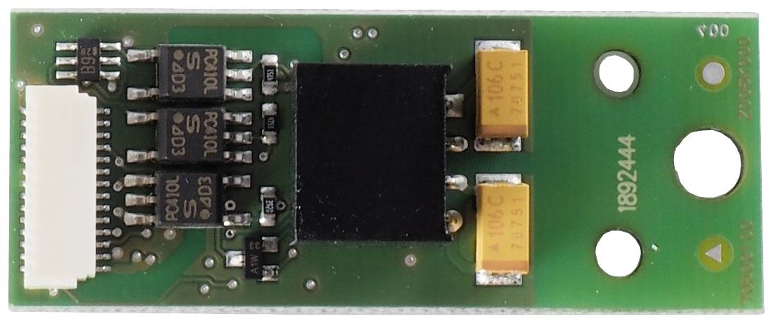 An electronic component with a green circuit board, several black chips, and two orange capacitors.