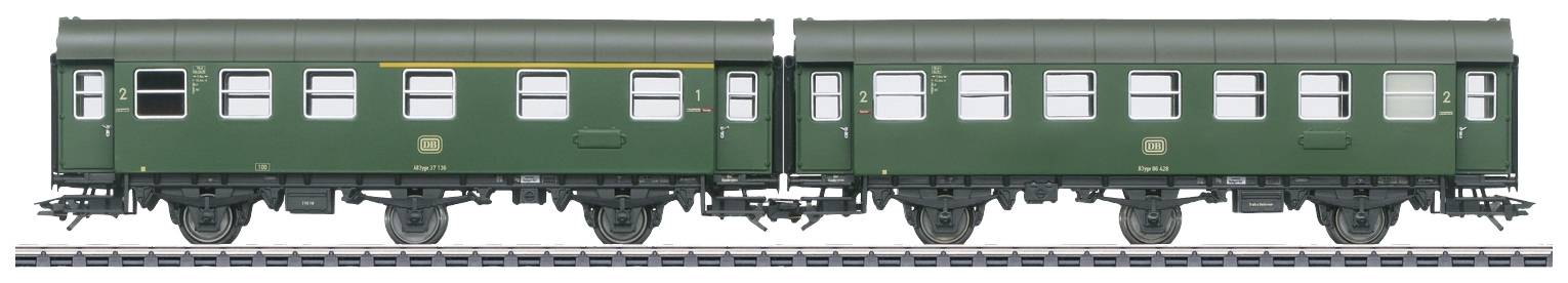 Two green railway carriages on a track, standing side by side, simple design without passengers or visible details.