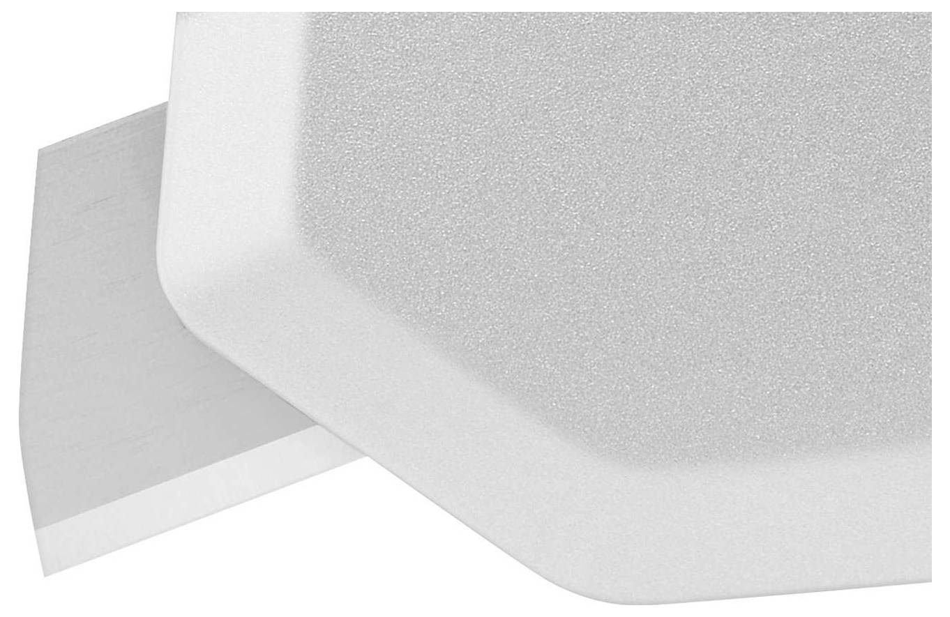 White foam corner and surface protector that shields an edge.