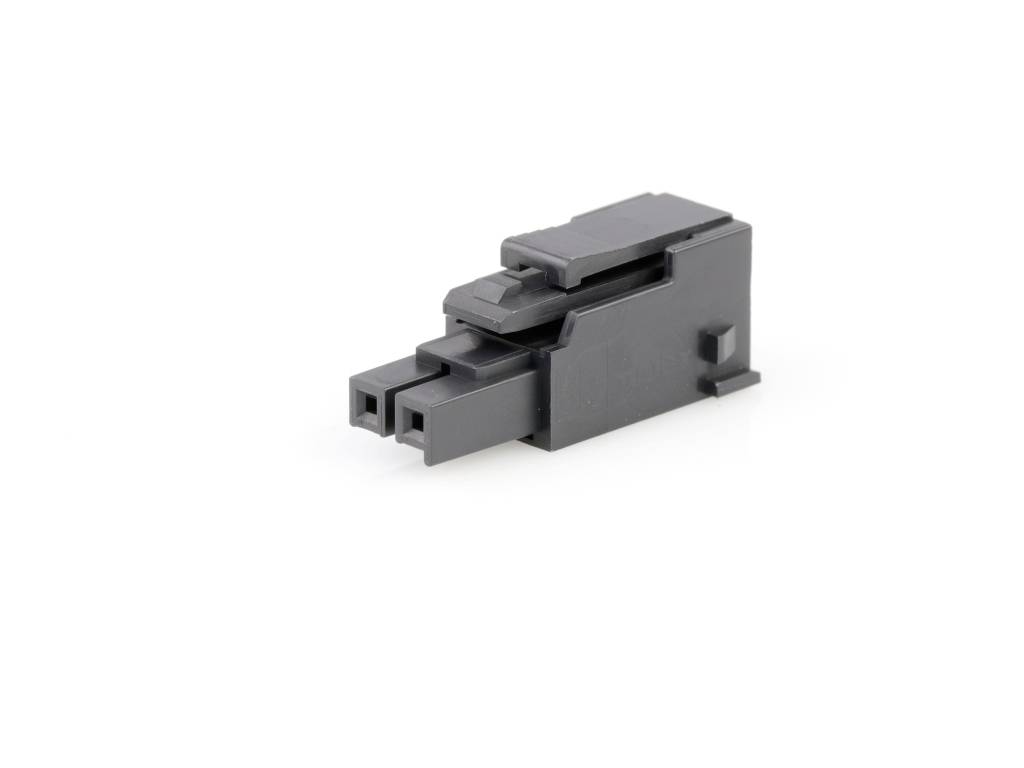 A black plastic connector is lying on a white surface.