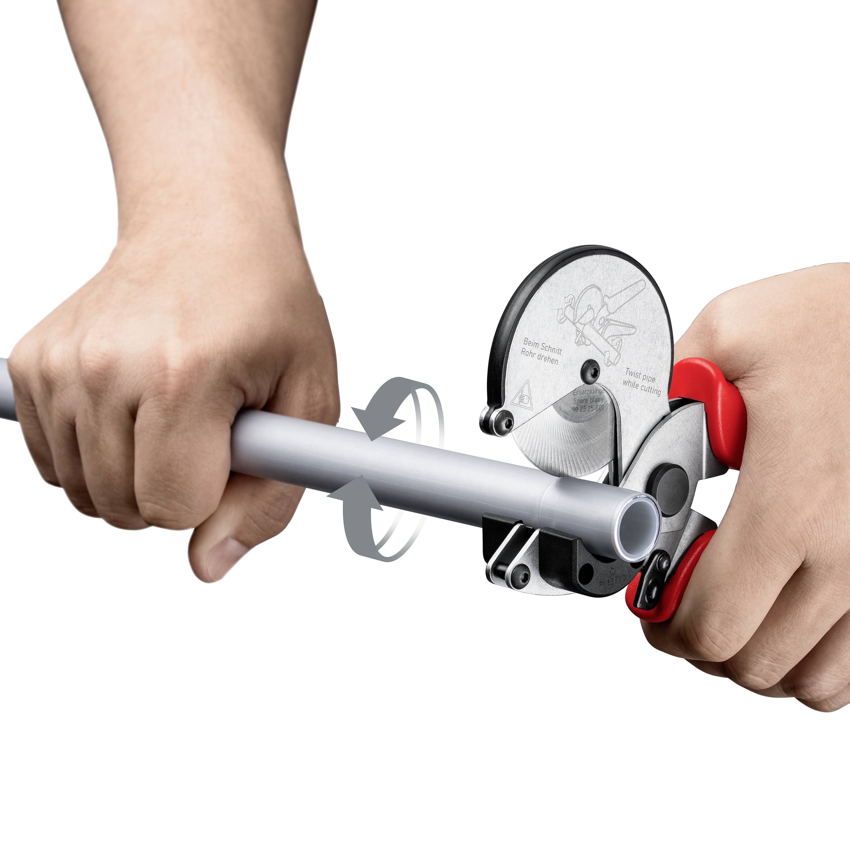 A person is using a manual pipe cutting tool to cut a metal pipe. The tool shows directional arrows for the cutting movement.