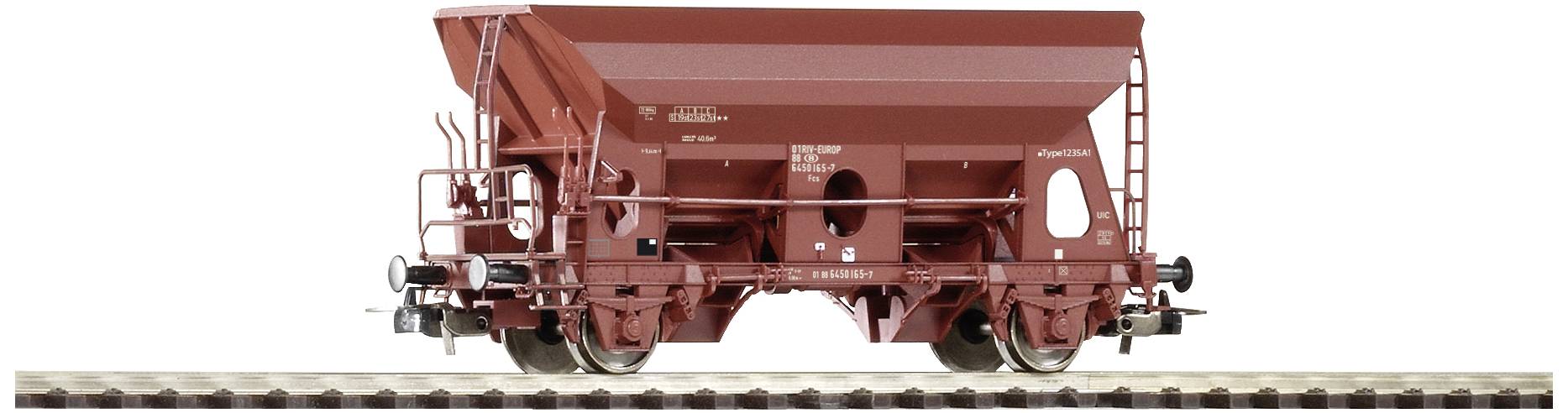 Red goods wagon on track, side view. The wagon has a funnel-shaped structure for bulk material transportation.