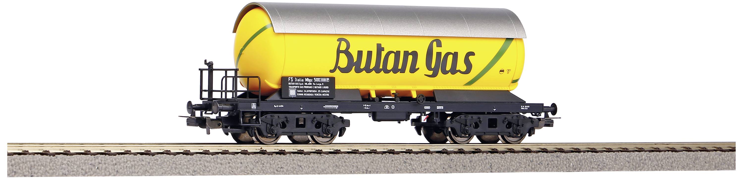 Yellow goods wagon with a silver roof and the inscription 'Bulan Gas' on a railway track.