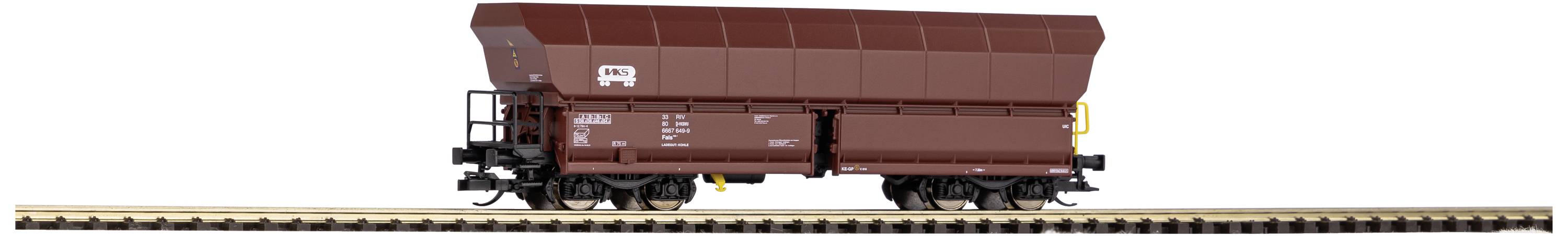 A brown goods wagon on a track, viewed from the side. The wagon is unmarked and is situated in a model railway setting.