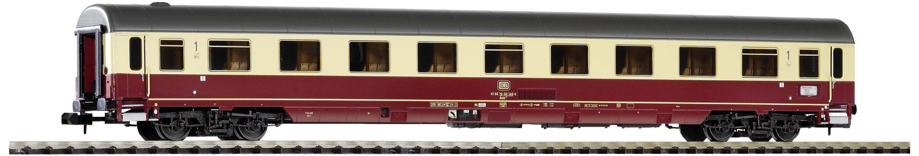 A model railway passenger carriage in red and beige, viewed from the side, stands on a track. The carriage is intricately designed.