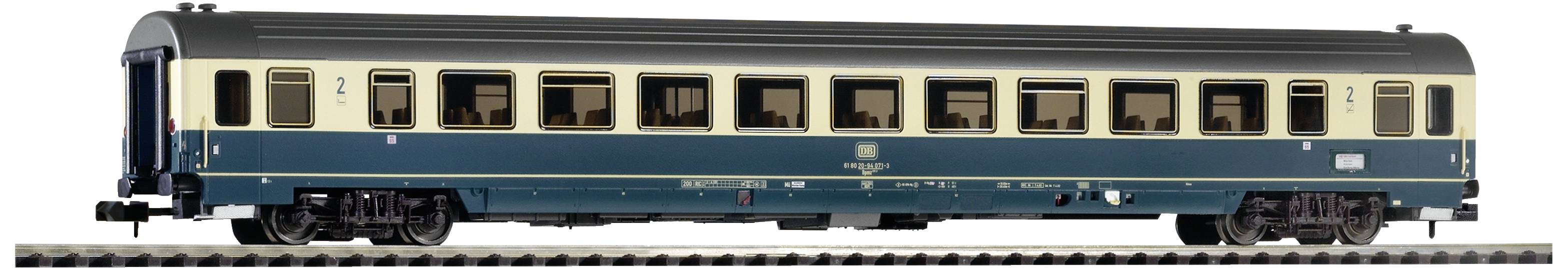 A blue and cream railway passenger carriage from the 1960s, side view, standing on a track.